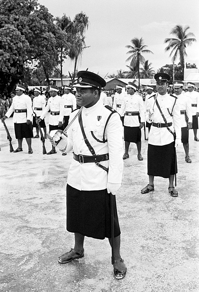 Soldiers in traditional uniforms wearing skirts in military parade in Kiribati, South Pacific