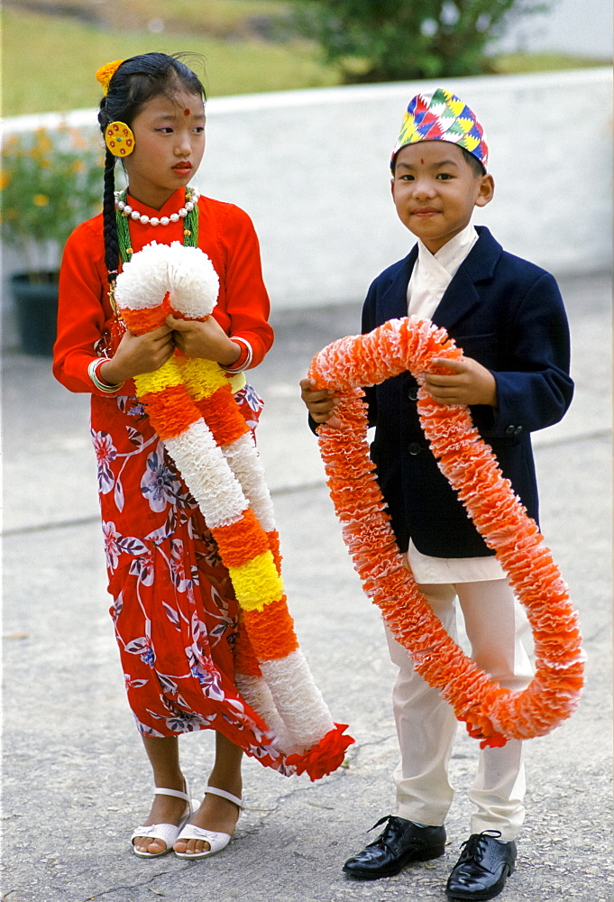 Nepalese children in traditional costumes with traditional welcome garlands