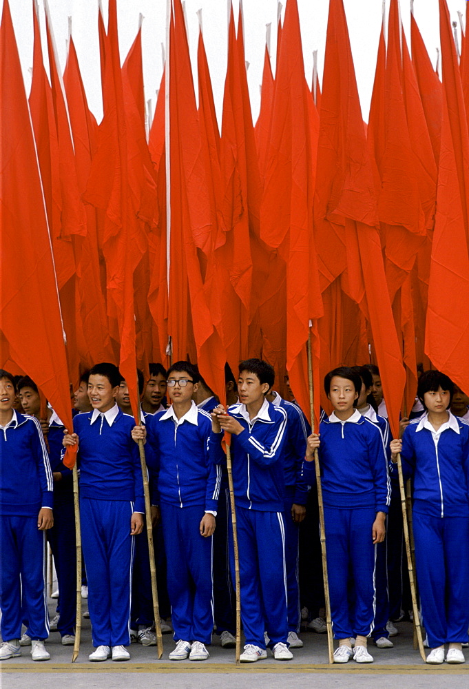 Young Chinese students with red flags at cultural display in Lintong,  China