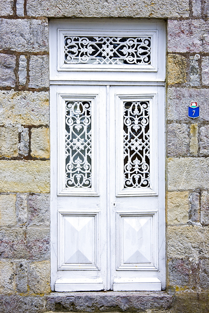 Ornate doorway in Domfront medieval town, Normandy, France