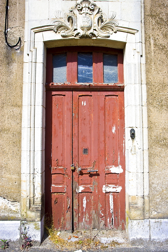 Weathered doorway in Ballee, Normandy, France