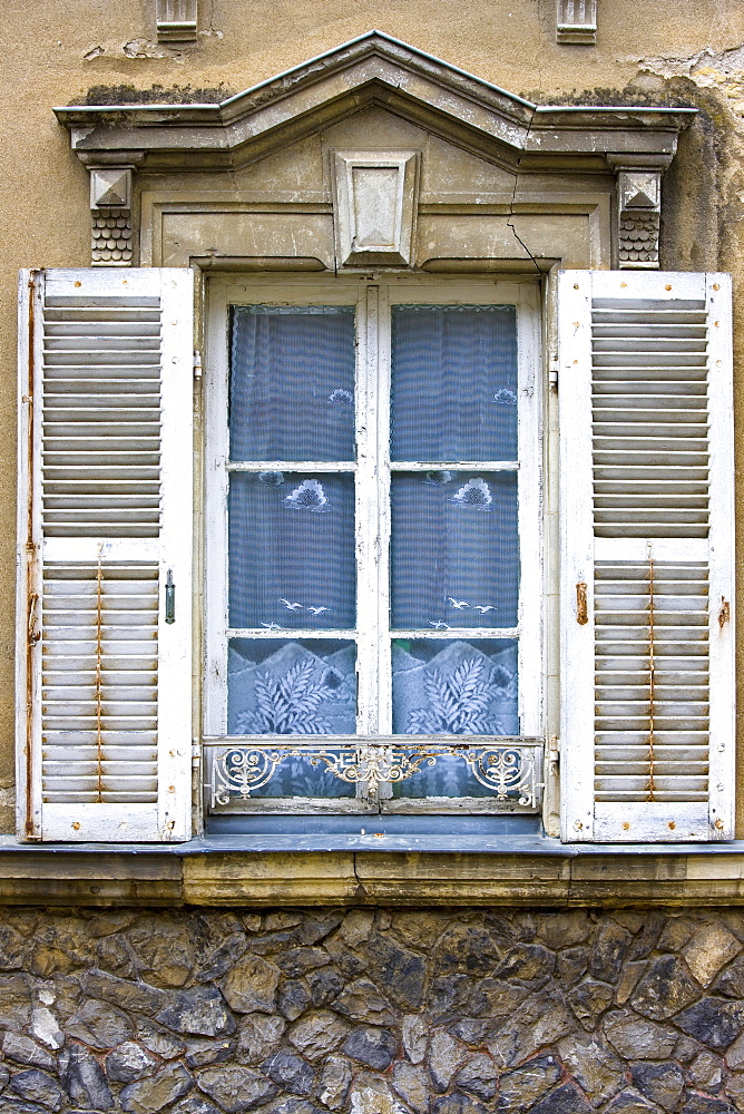 Traditional French window with shutters in Precigne, Pays de la Loire, France