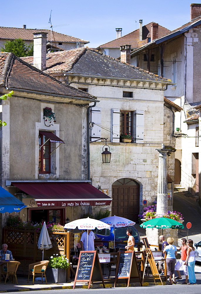 Tourists in quaint town of Bourdeilles popular tourist destination near Brantome in Northern Dordogne, France