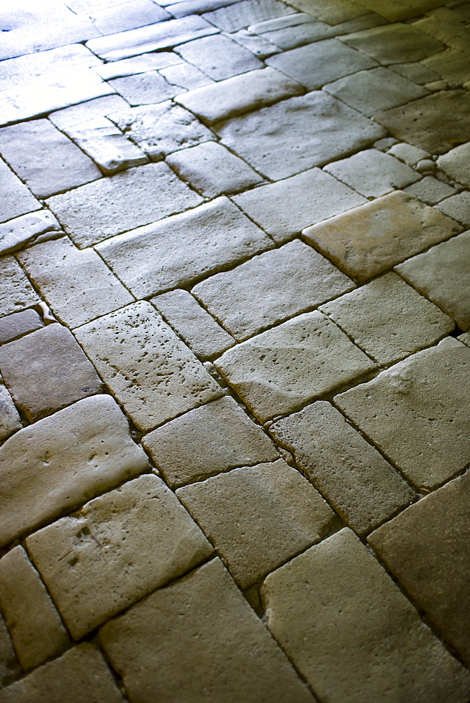 Old stone floor in the ancient church at St Amand de Coly in the Dordogne, France