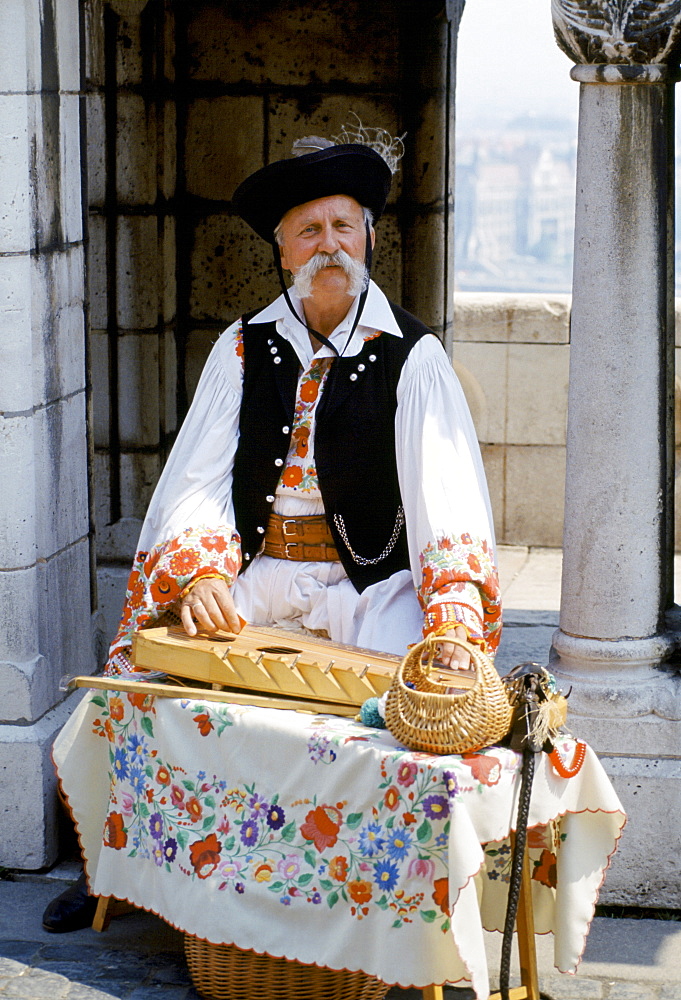 Hungarian man in traditional clothing with Hungarian musical instrument in Budapest, Hungary