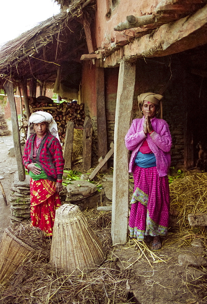 Namaste welcome greeting from women in traditional clothing at home in the foothills of the Himalayas at Pokhara in Nepal