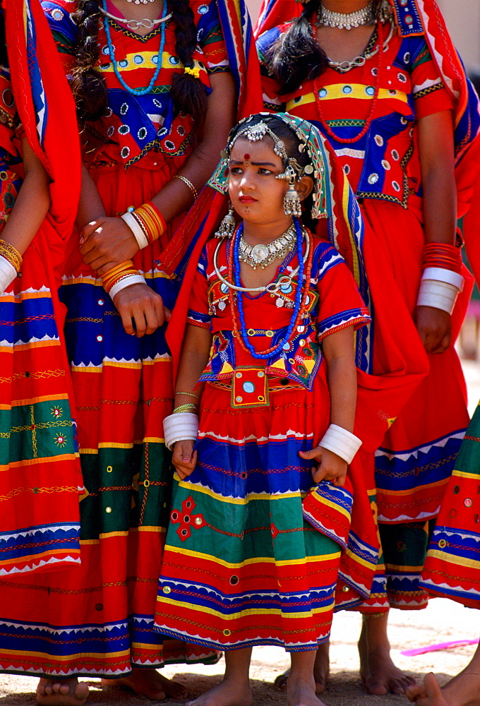 Young pretty girls in brightly coloured national costume and jewels at a festival in Calcutta, India