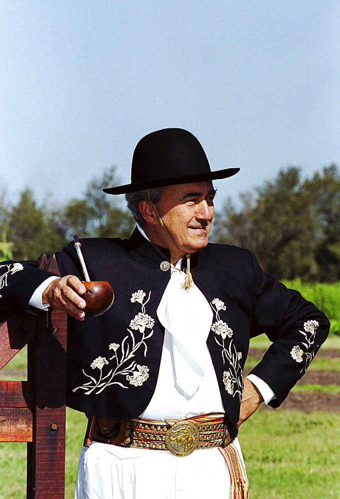 Gaucho in traditional costume drinking local speciality mate tea at Las Brujas Ranch, Uruguay