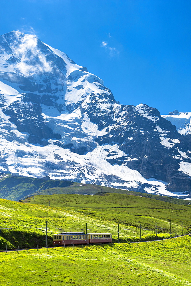 Jungfraubahn funicular train climbs to the Jungfrau from Kleine Scheidegg in the Swiss Alps in Bernese Oberland, Switzerland, Europe