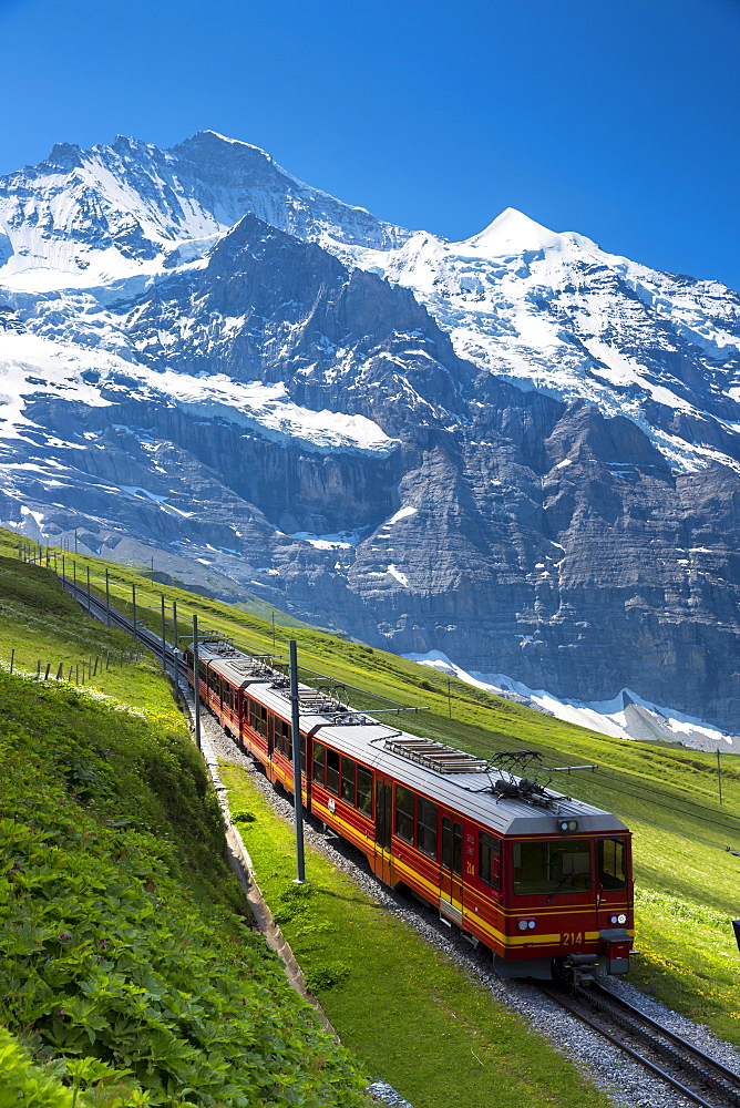 Jungfraubahn funicular train climbs to the Jungfrau from Kleine Scheidegg in the Swiss Alps in Bernese Oberland, Switzerland, Europe