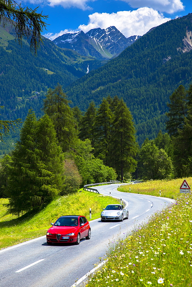 Alfa Romeo and Porsche 911 on touring holidays in the Swiss Alps, Swiss National Park, Switzerland, Europe