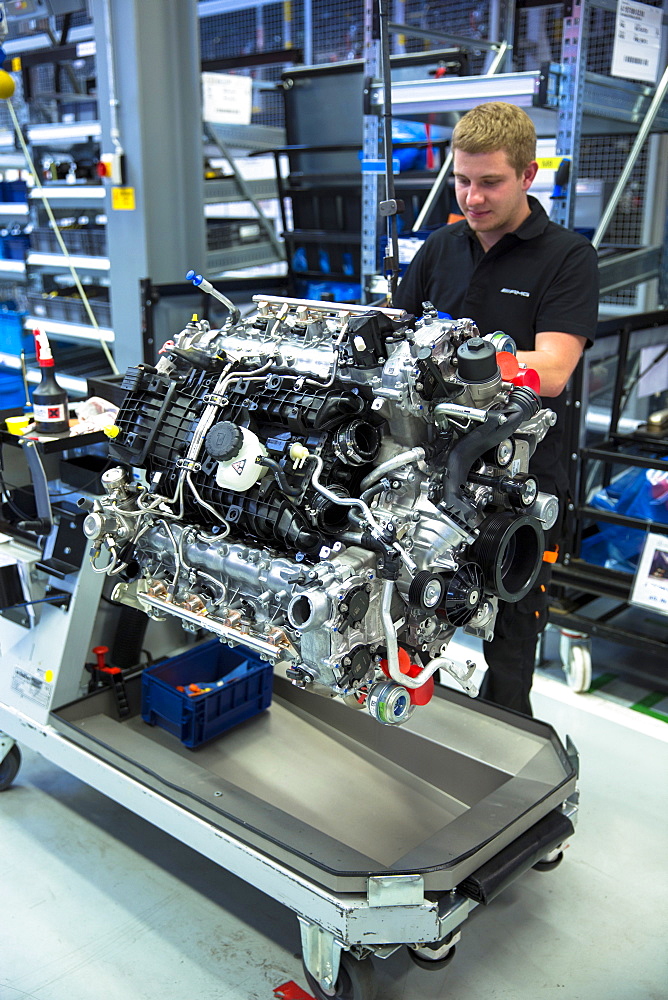 Engineer at work hand-building one complete M157 5.5L V8 biturbo engine, Mercedes-AMG engine production factory in Affalterbach, Bavaria, Germany, Europe