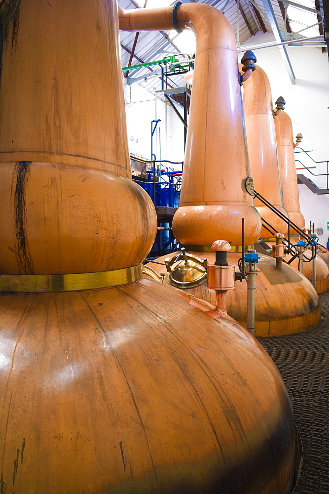 Copper stills for whisky process in traditional Still House part of Visitor Centre visitors tour at Tobermory Distillery, Isle of Mull, Inner Hebrides and Western Isles, Scotland, United Kingdom, Europe