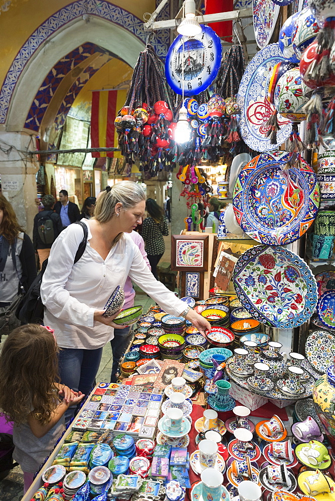 Western woman tourist buying hand-painted ceramics in The Grand Bazaar (Great Bazaar) (Kapali Carsi),  Beyazi, Istanbul, Turkey, Europe