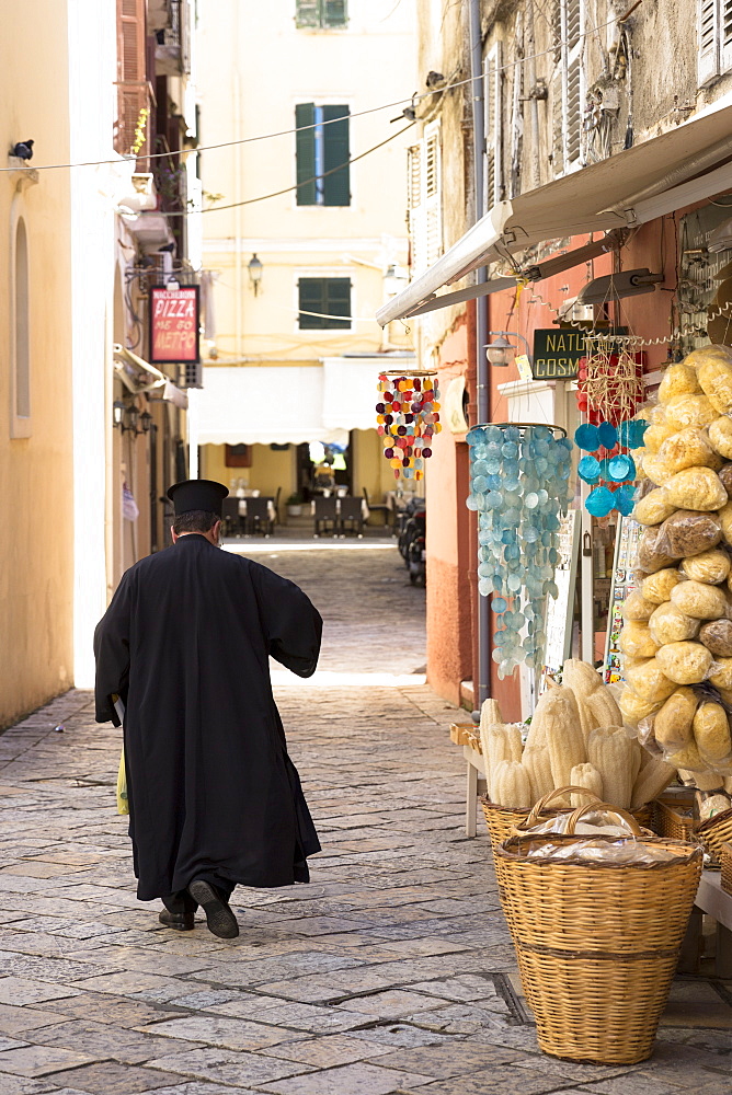 Greek Orthodox priest in traditional robes in street scene in Kerkyra, Corfu Town, Corfu, Greek Islands, Greece, Europe