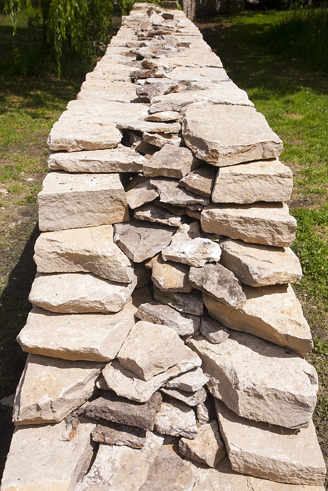 Newly built dry stone wall constructed of new Cotswolds stone using traditional old methods, Oxfordshire, England, United Kingdom, Europe