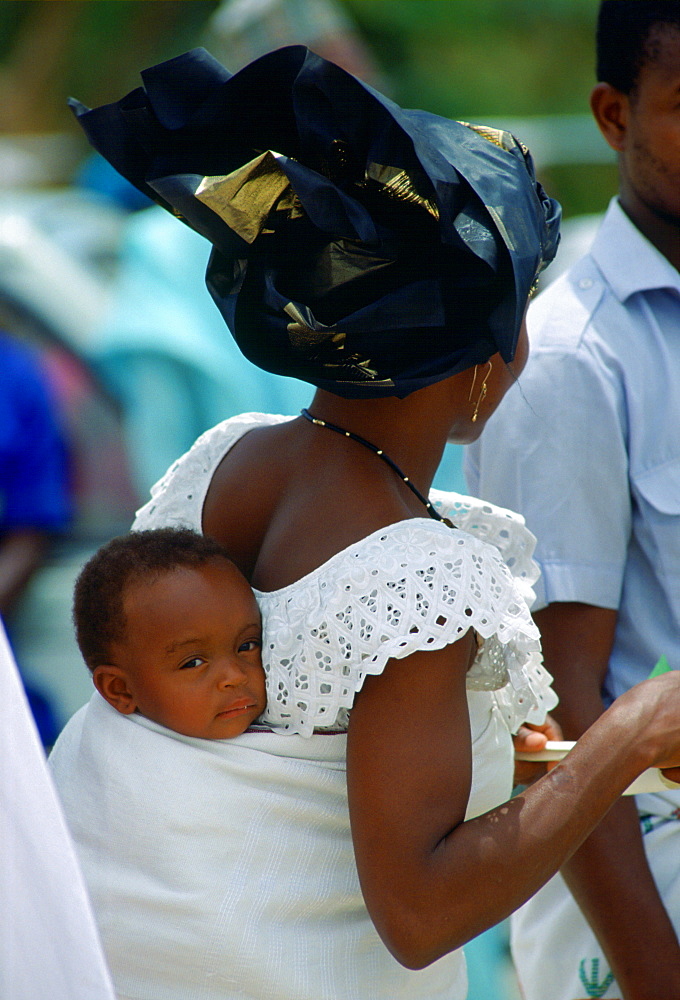 Child held close in a shawl wrap, Nigeria