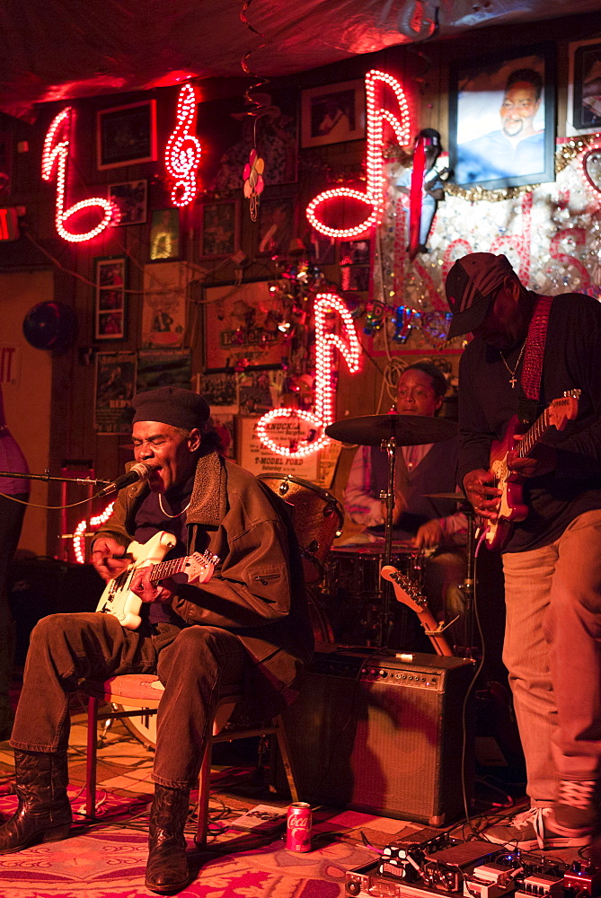 Blues band, guitarist, drums, vocals in live performance on stage at Red's Lounge Blues Club in Clarksdale, Mississippi, USA