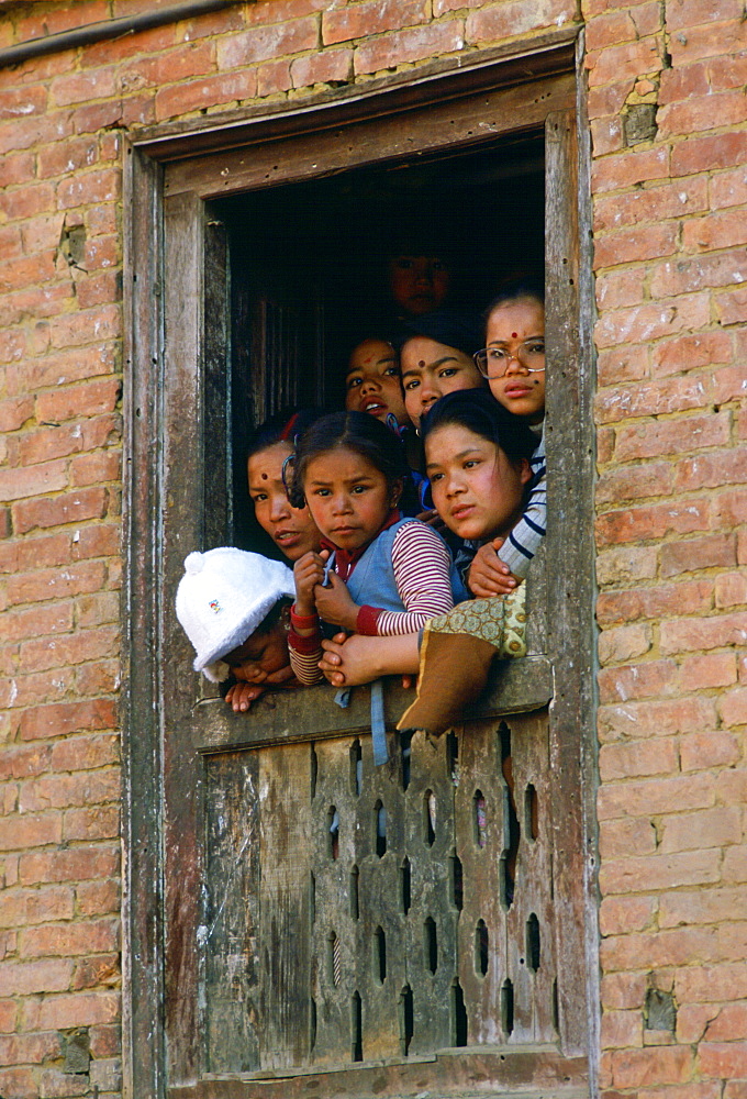 Family  at window  to watch festival in Bhaktapur, Nepal