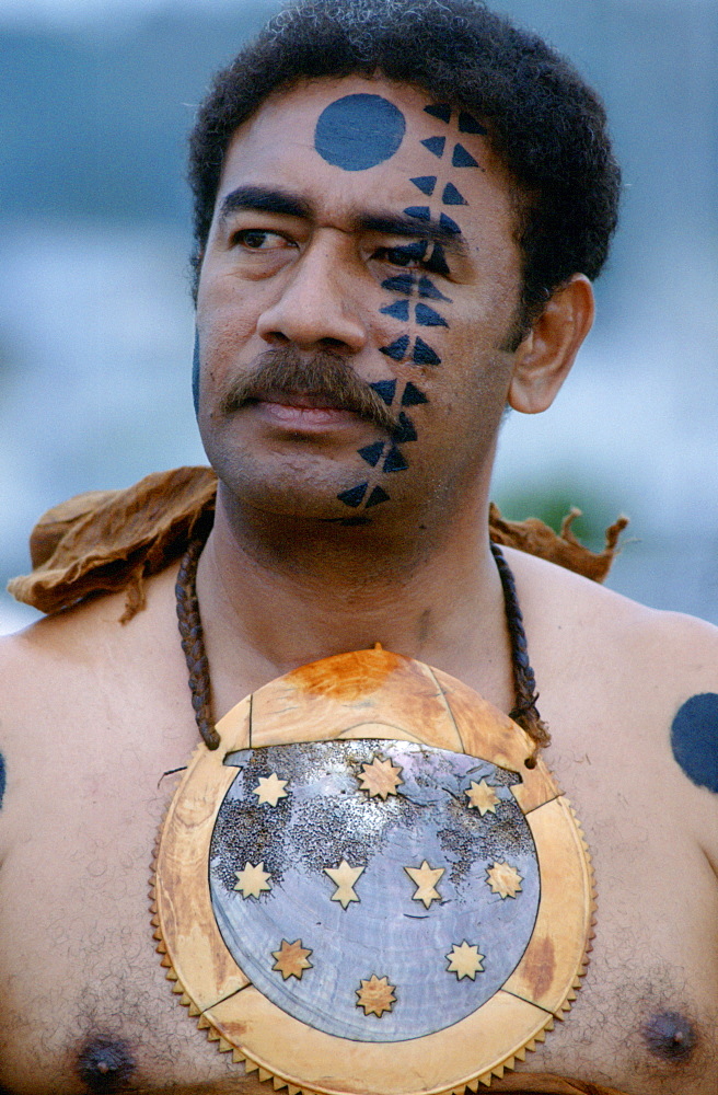 Fijian warrior withhis face painted in the traditional manner and wearing a breastplate while attending a tribal gathering in Fiji, South Pacific