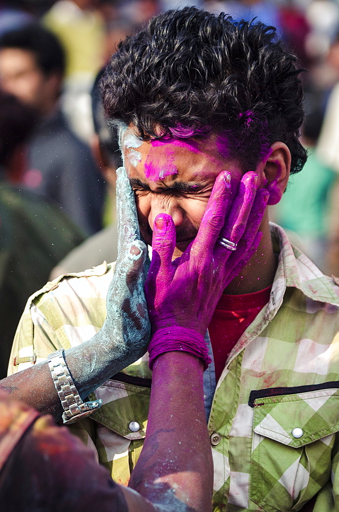 Two men exchange coloured powder during Holi festival celebrations, Basantapur Durbar Square, Kathmandu, Nepal, Asia 