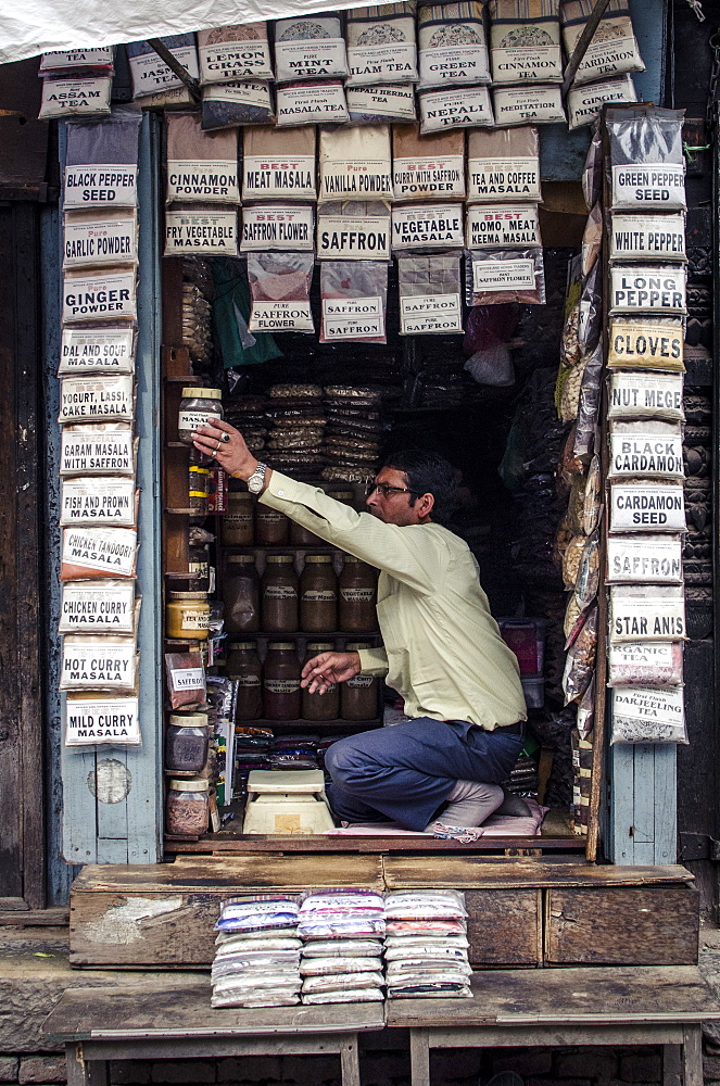 A spice seller arranges his stock, Kathmandu, Nepal, Asia 