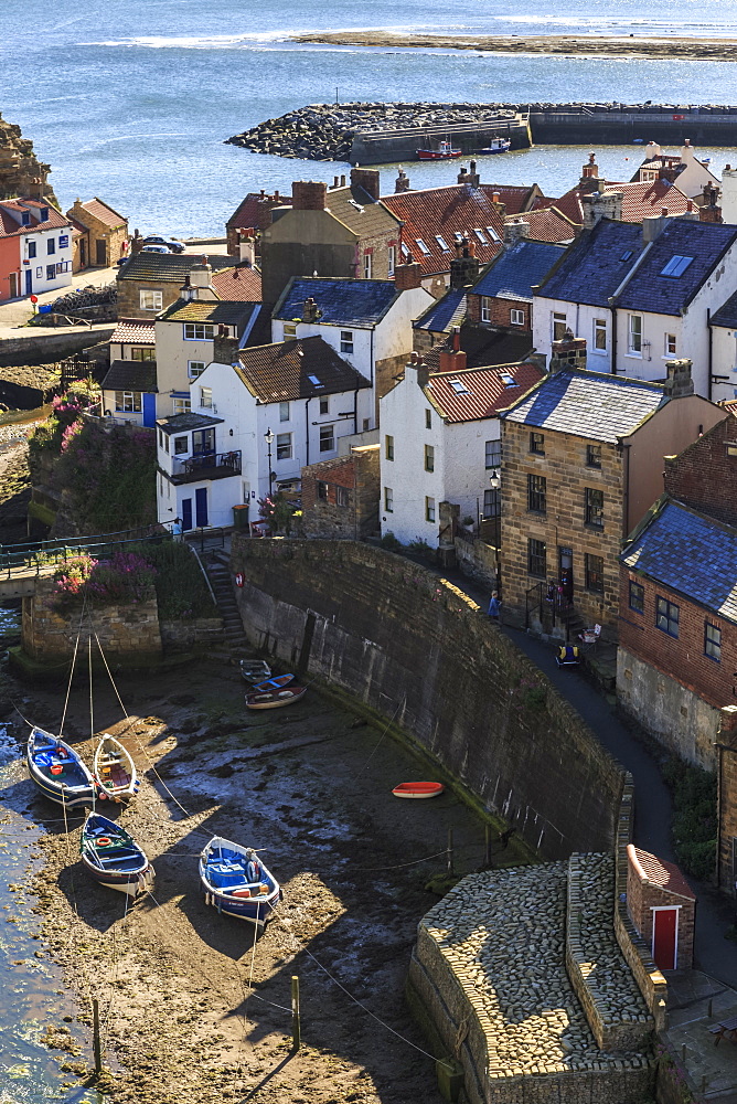 Winding alleys of village, fishing boats and sea, elevated view in summer, Staithes, North Yorkshire Moors National Park, Yorkshire, England, United Kingdom, Europe