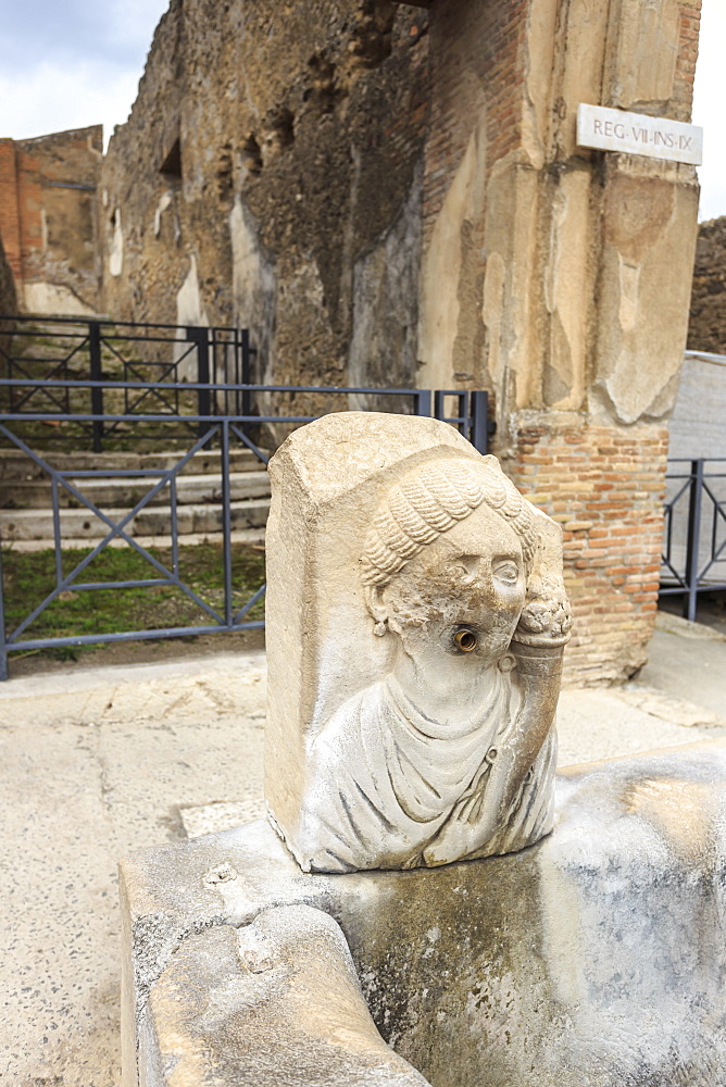 Public fountain on cobbled street, Roman ruins of Pompeii, UNESCO World Heritage Site, Campania, Italy, Europe