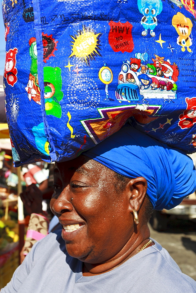 Lady with shopping bag on head, market, Roseau, Dominica, West Indies, Caribbean, Central America