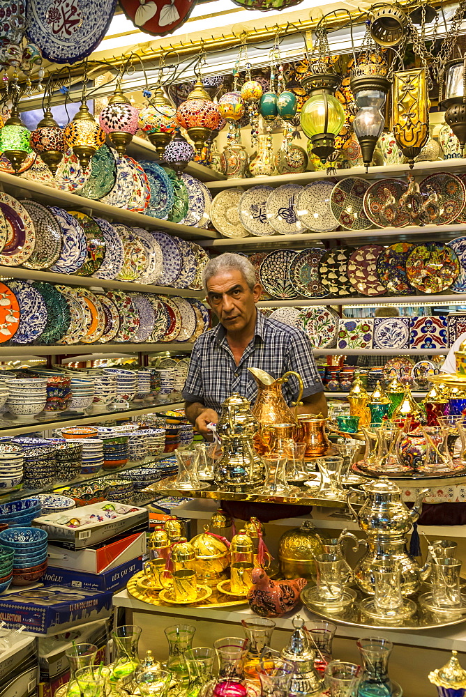 Seller (vendor) of traditional Turkish ceramics, glassware and tea sets in his shop, Grand Bazaar, Istanbul, Turkey, Europe