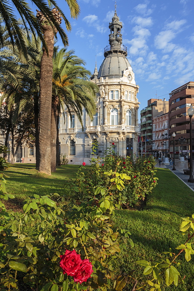 Town Hall under a cloud dappled blue sky with palm trees and roses, Cartagena, Murcia Region, Spain, Europe