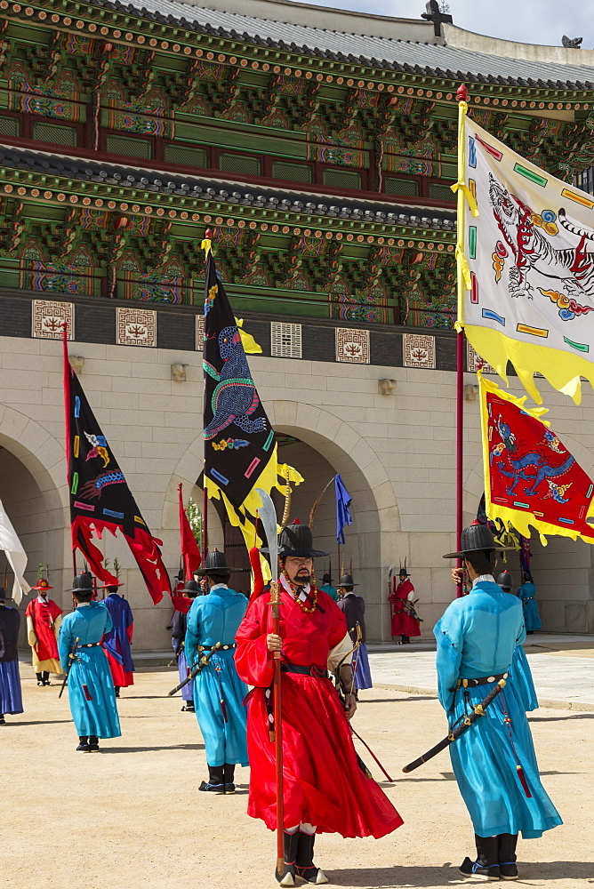 Marching with flags at Gwanghwamun gate, colourful Changing of the Guard Ceremony, Gyeongbokgung Palace, Seoul, South Korea, Asia