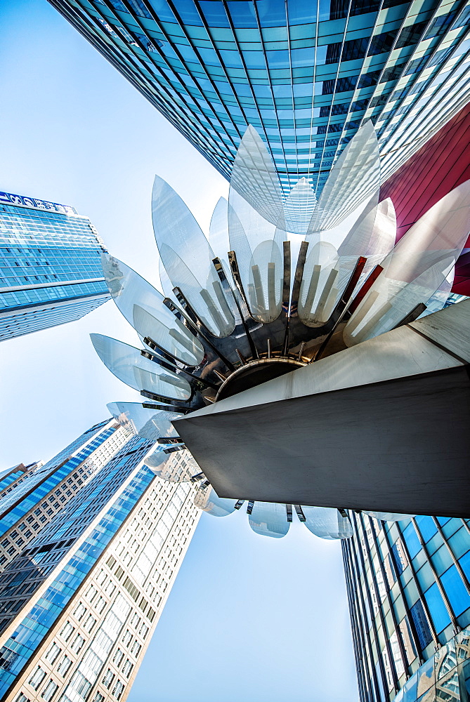 Glass and metal Lotus installation in front of HSBC Bank with surrounding new skyscrapers in Jianggan district, Hangzhou, Zhejiang, China, Asia