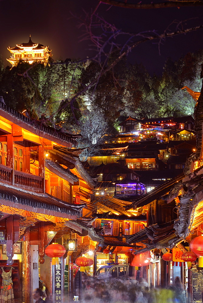 Busy Lijiang Old Town, UNESCO World Heritage Site, at night with Lion Hill and Wan Gu Tower, Lijiang, Yunnan, China, Asia 