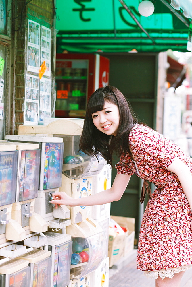 Japanese girl buying candies at an old candy shop