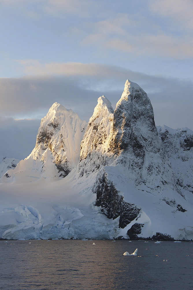 Sunrise on the mountain tops at the north entrance to the Lemaire Channel along the Antarctic Peninsula, Lemaire Channel, Antarctic Peninsula