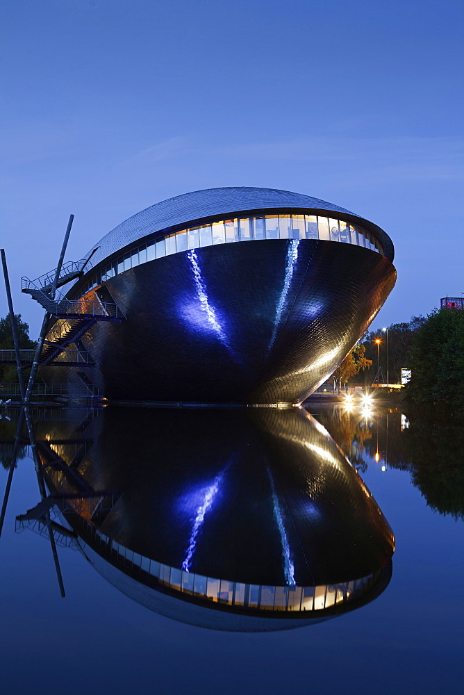 Symmetrical reflection of Atlantic Hotel Universum at night, Bremen, Germany