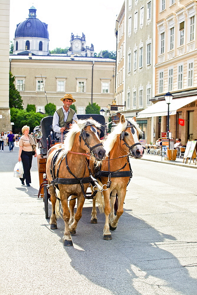 Man sitting on horse carriage, Salzburg, Austria