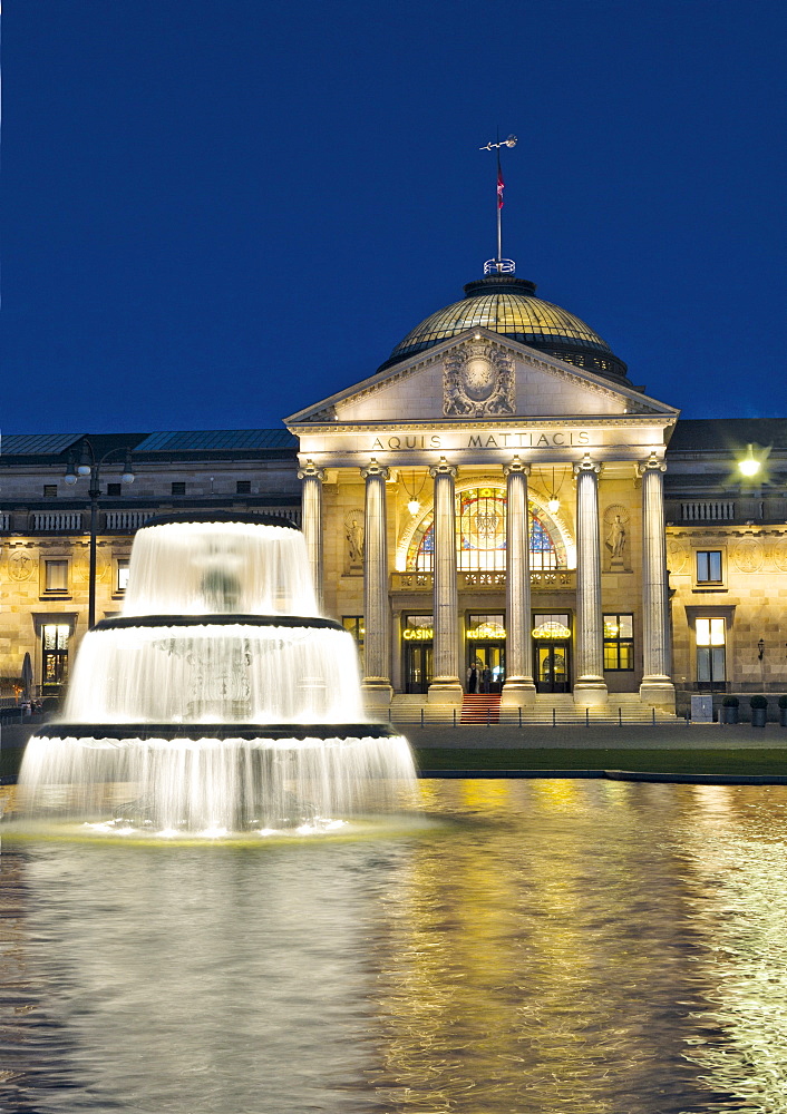 Facade of illuminated Kurhaus and fountain at Wiesbaden, Hesse, Germany