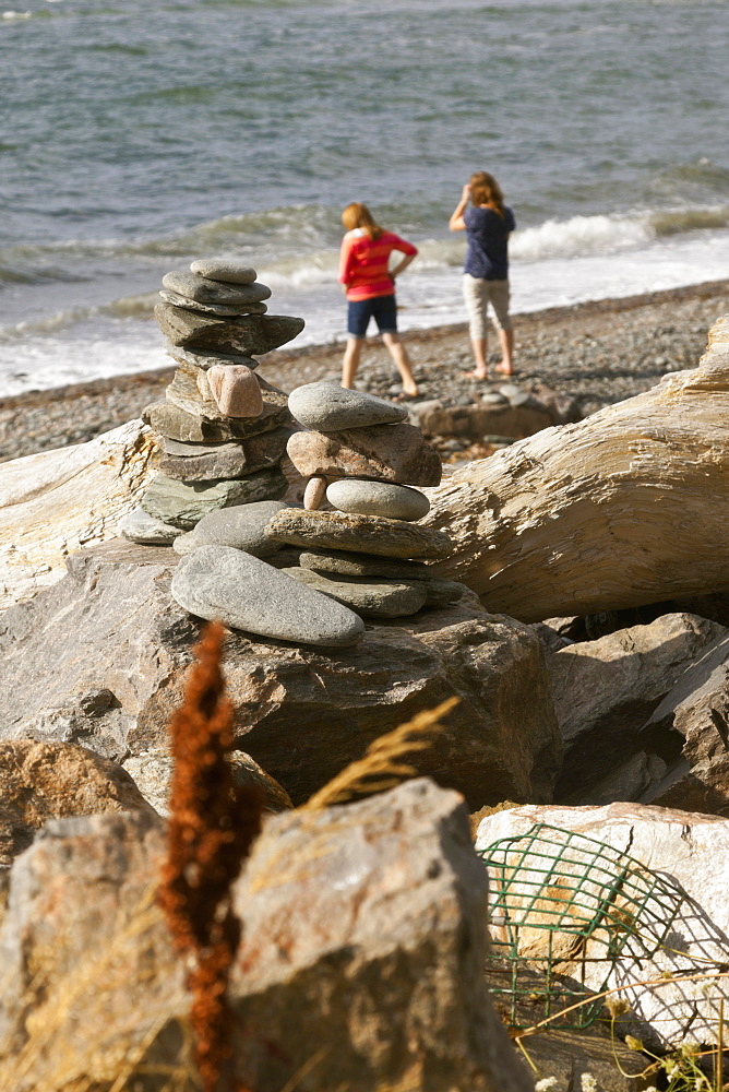 Rear view of two women standing on beach at Cape Breton Island, Canada