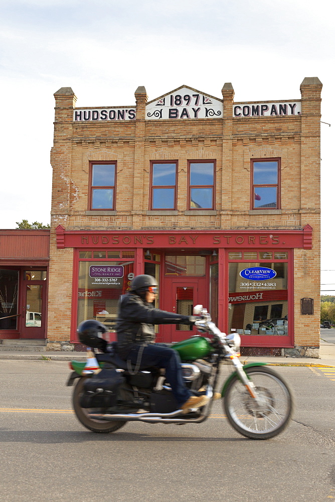 Biker in front of Hudson's Bay Company Store in Fort Qu'Appelle, Saskatchewan, Canada