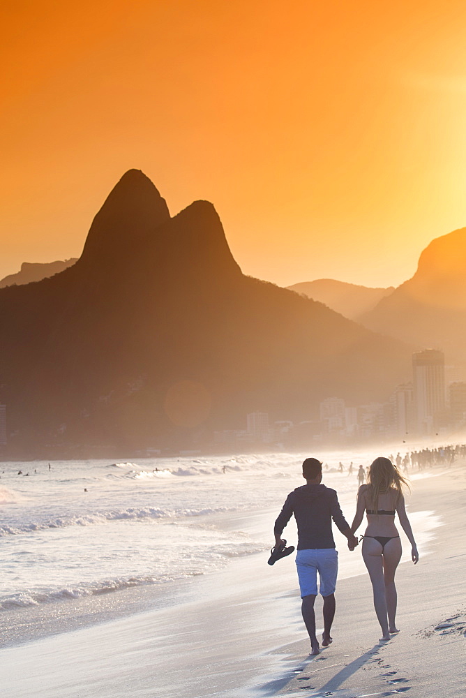 Ipanema and Leblon beach at sunset with the Morro dos Dois Irmaos (Two Brothers) hills behind, Rio de Janeiro, Brazil, South America