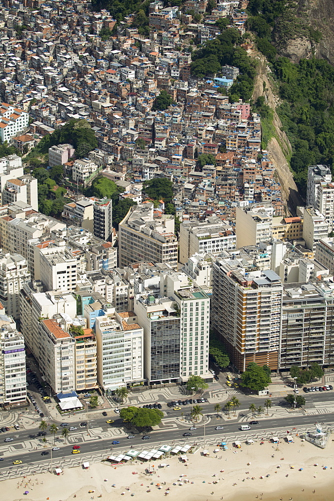 Copacabana Beach, neighbourhood and the Morro da Humaita favela behind, Rio de Janeiro, Brazil, South America