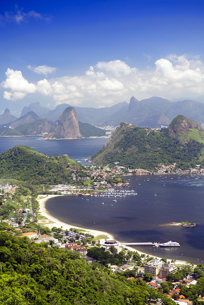 View of Rio, the Serra da Carioca mountains and Sugar Loaf with Charitas and Sao Francisco beaches in Niteroi in the foreground, Rio de Janeiro, Brazil, South America