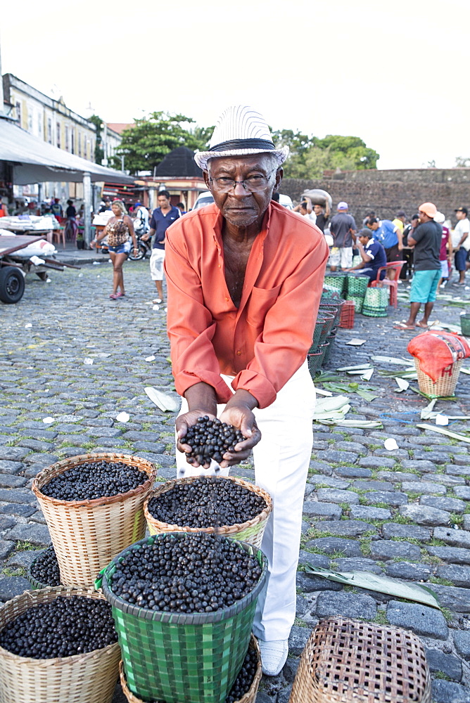 A man selling Acai berries at the morning market, Belem, Para, Brazil, South America