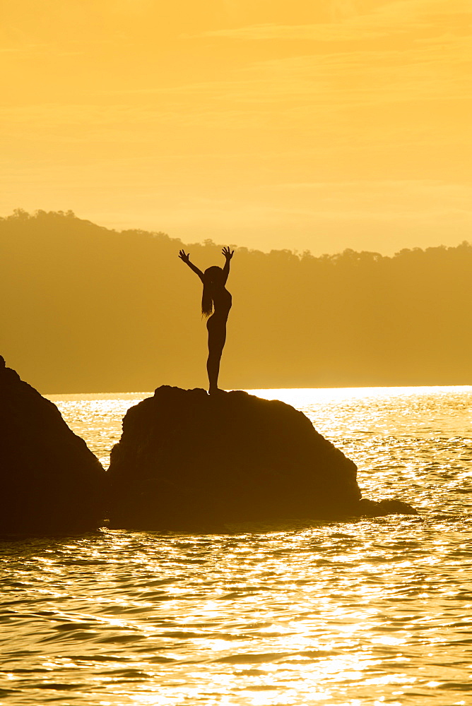 A young woman performing yoga, Puntarenas, Costa Rica, Central America