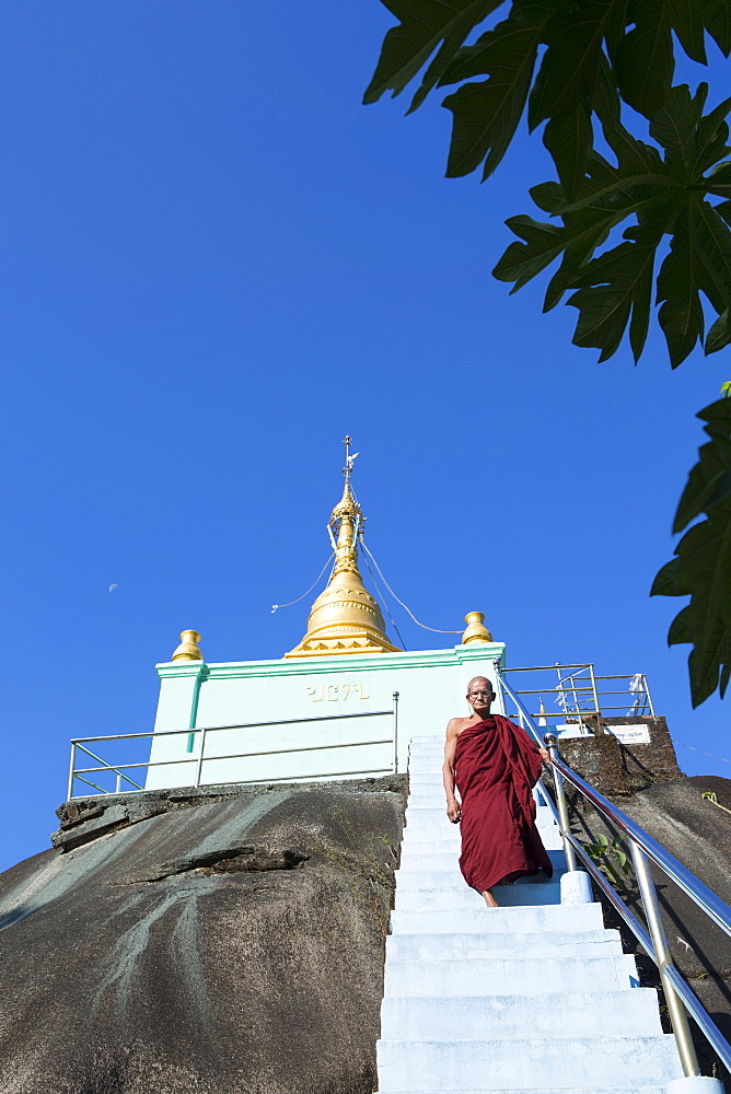 Giant boulder topped by a golden stupa looked after by a buddhist monk, Dawei, Tanintharyi, Myanmar (Burma), Southeast Asia