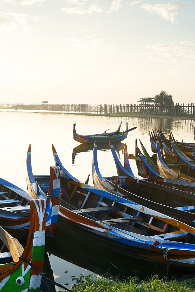 Boats on the Taungthaman Lake near Amarapura with the U Bein teak bridge behind, Mandalay, Myanmar (Burma), Southeast Asia