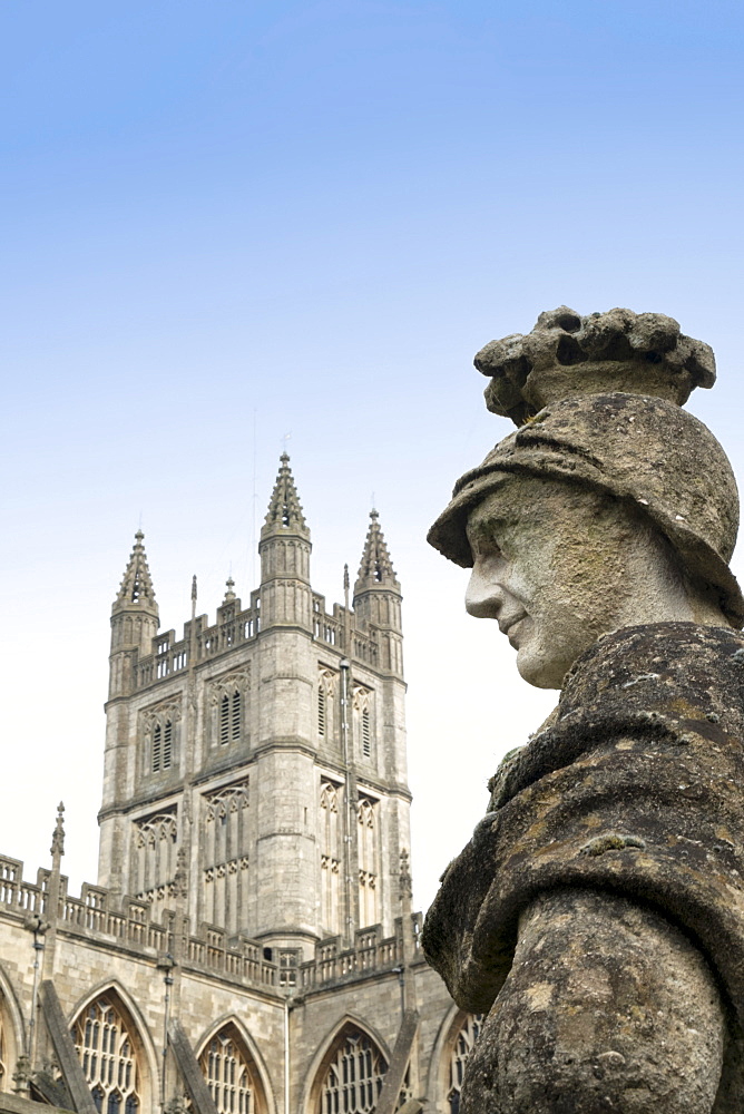 Bath Abbey and a Roman statue in the Roman Baths, Bath, UNESCO World Heritage Site, Somerset, England, United Kingdom, Europe