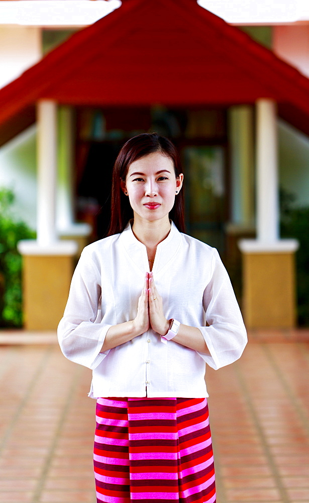 Woman making a Thai Wai salute in Lamphun, Thailand, Southeast Asia, Asia